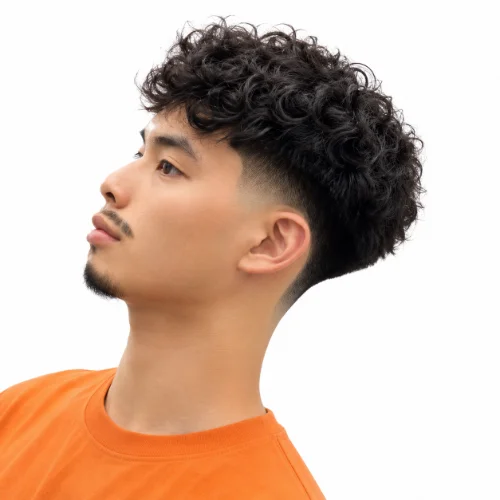 Asian man with a modern Asian mullet fade and curly hair